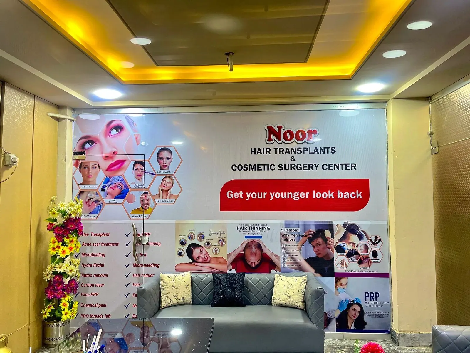 Clinic waiting area with seating and wall signage